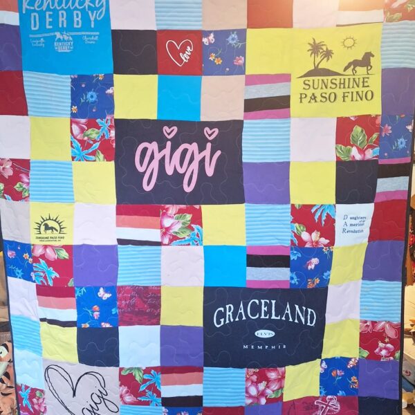 A hand-made memory quilt with the word "Gigi" on it